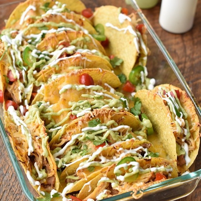 Platter of street tacos loaded with cilantro and lime